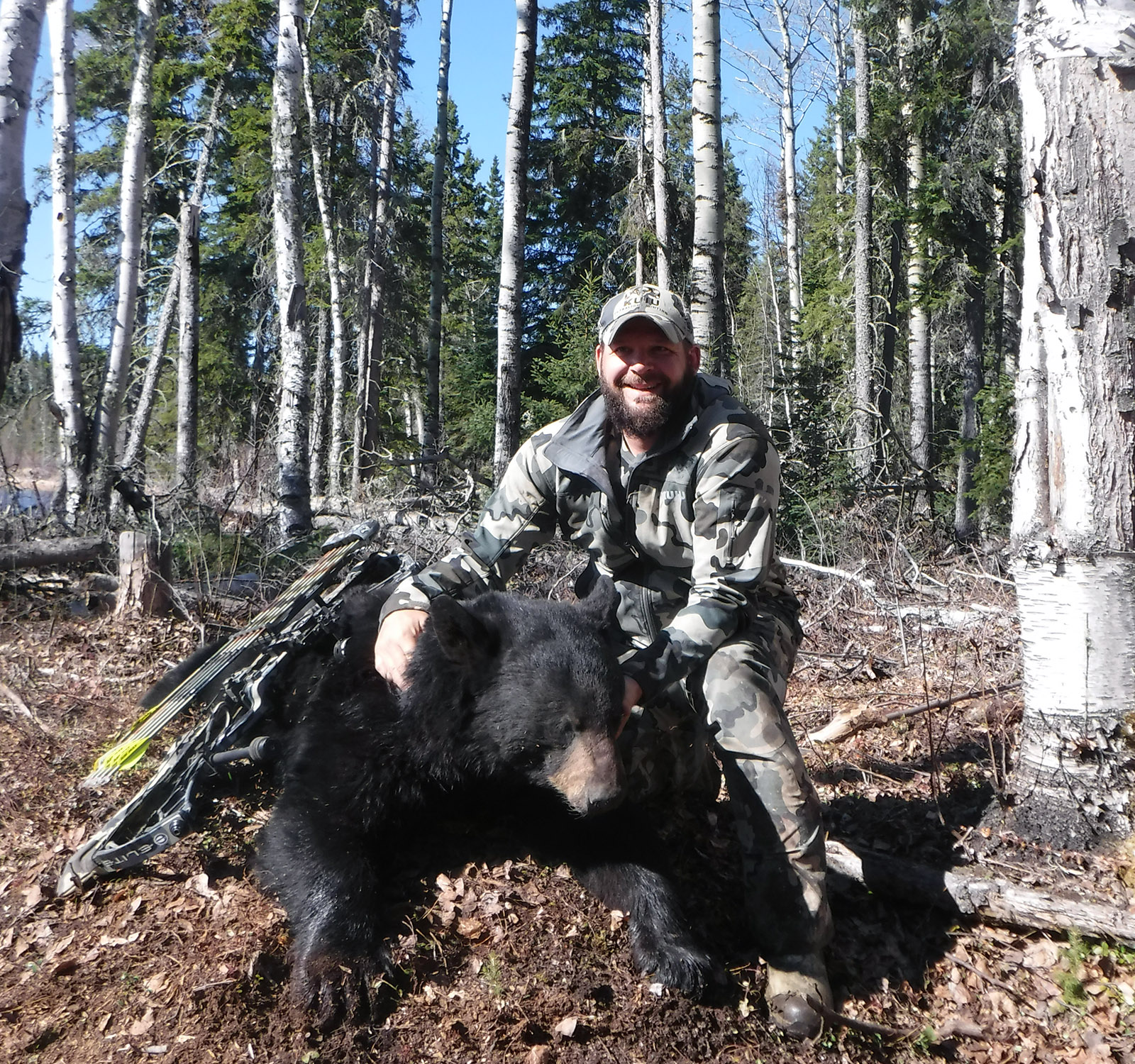 hunter posing with black bear